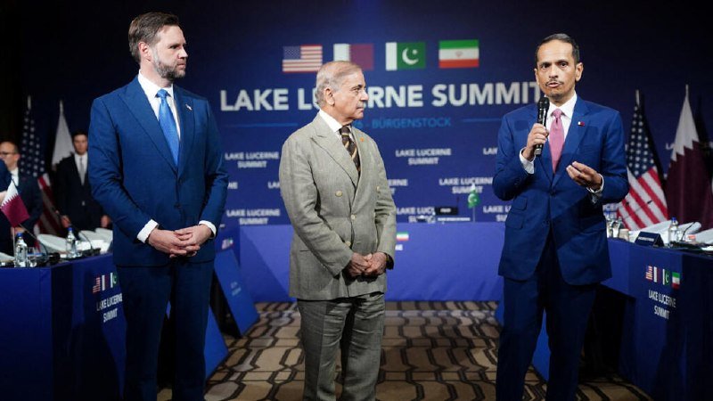 Three men in suits stand at a podium before a backdrop displaying flags and "Lake Lucerne Summit" branding, with one man speaking into a microphone.
