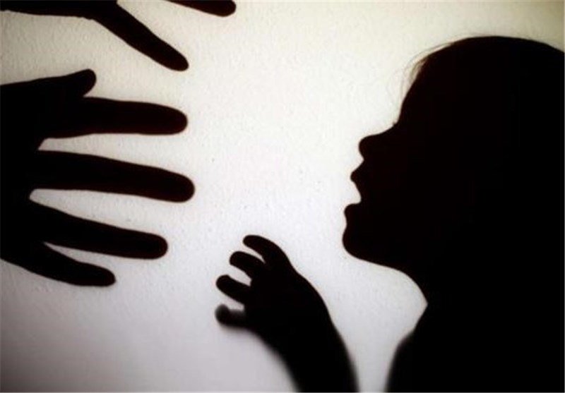 Silhouetted shadows of outstretched hands and a child's face with an open mouth are projected onto a light-colored wall, suggesting distress.