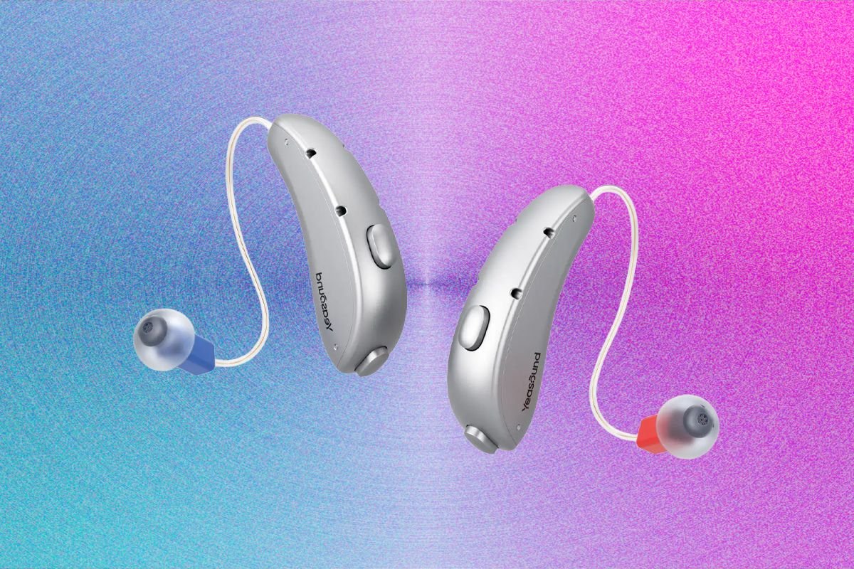 Two gray behind-the-ear hearing aids branded "Puresound" float against a pink and blue gradient background.