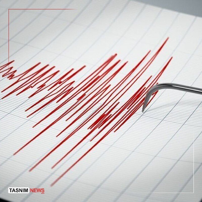 A seismograph displays a red jagged reading on grid paper with a metal stylus, marked "TASNIM NEWS."
