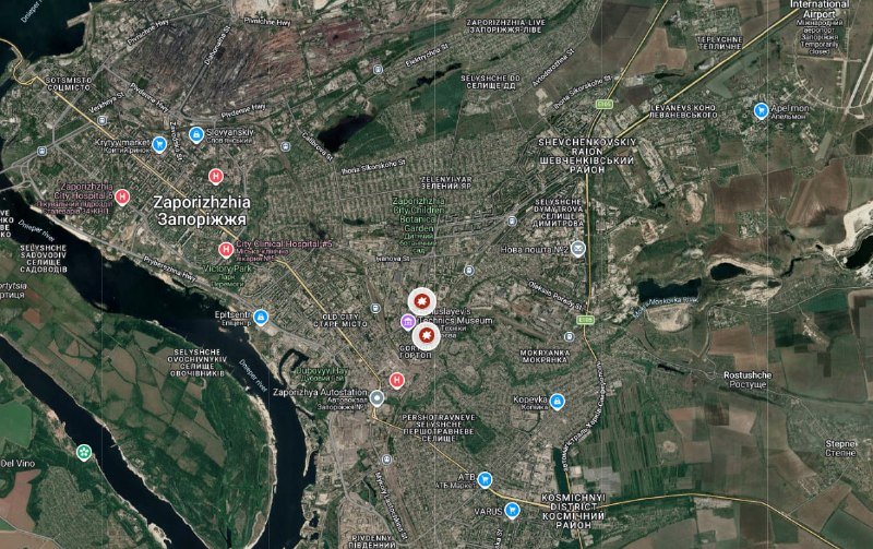 Satellite map of Zaporizhzhia showing the Dnipro River and labeled neighborhoods with three red target icons clustered in the central district.