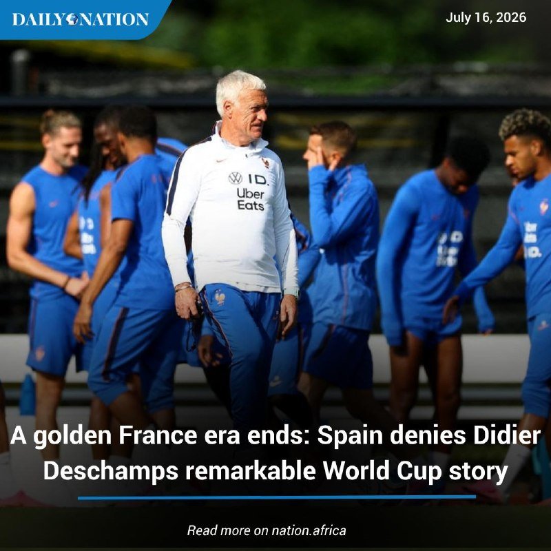 A grey-haired man in a white "Uber Eats" training top walks among players in blue kits on a training pitch, dated July 16, 2026.