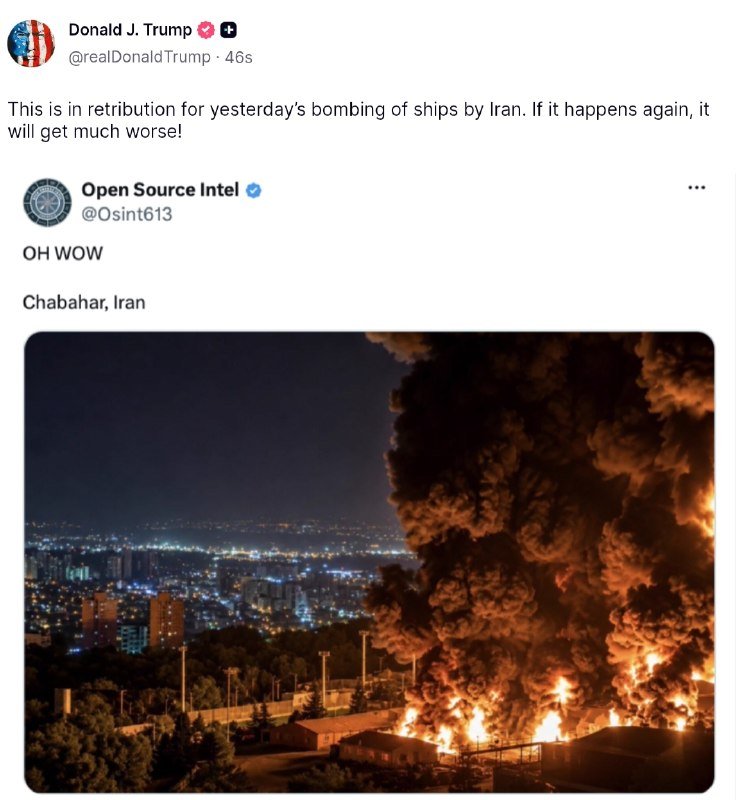 A nighttime photograph shows a massive fire and thick smoke rising from a port facility, with illuminated city buildings visible in the background.