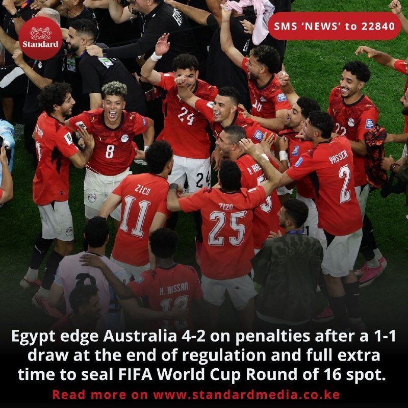 Soccer players in red jerseys with "EGYPT" and numbers 2, 8, 11, 22, 24, and 25 celebrate in a huddle on the field.