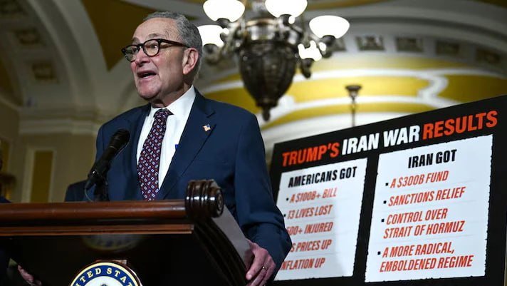 A man in a dark suit speaks at a podium beside a sign reading "TRUMP'S IRAN WAR RESULTS," listing outcomes for "AMERICANS" and "IRAN."
