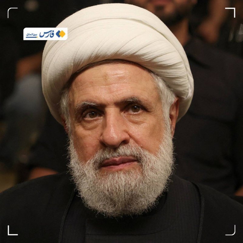 A close-up portrait shows an older man with a white beard wearing a white turban and black clothing, with a news agency logo in the corner.
