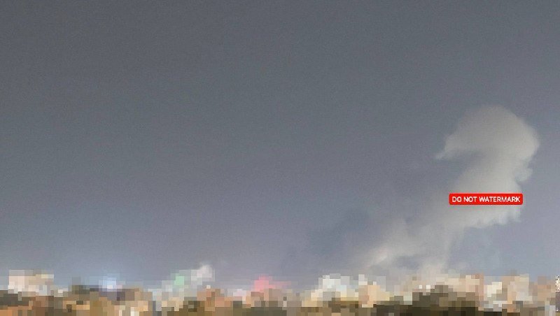 A grayscale cityscape at night sits beneath a cloudy sky, with a red "DO NOT WATERMARK" label visible on the right.