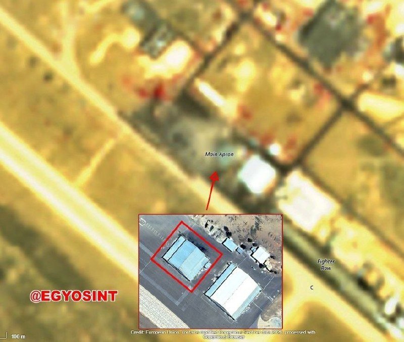 A satellite image shows an industrial facility with a large rectangular building outlined in red, labeled "Main Apron," alongside road infrastructure and surrounding fields.