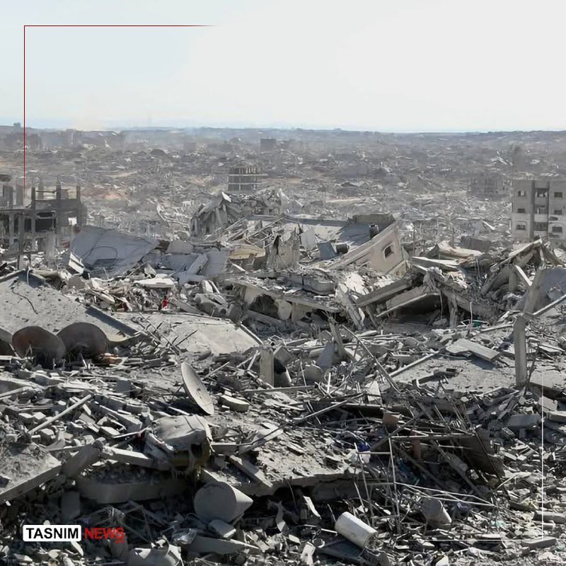Vast landscape of flattened buildings, concrete rubble, twisted rebar, and scattered debris stretching to the horizon, watermarked "TASNIM NEWS."