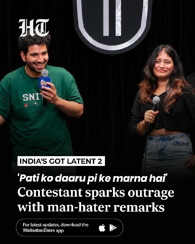 A smiling man in a green T-shirt holding a microphone stands beside a woman holding a microphone, in front of a black backdrop with a "IGL" logo.