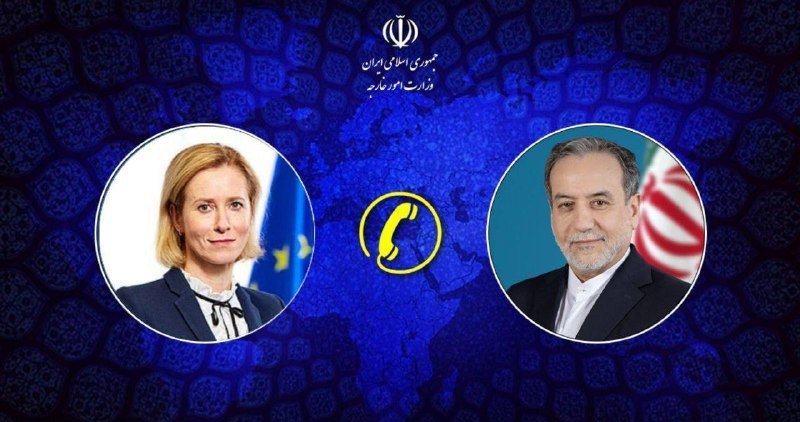 A graphic illustration against a blue patterned background displays circular portraits of a blonde woman beside an EU flag and a bearded man beside an Iranian flag, with a phone icon and Iranian government emblem between them.